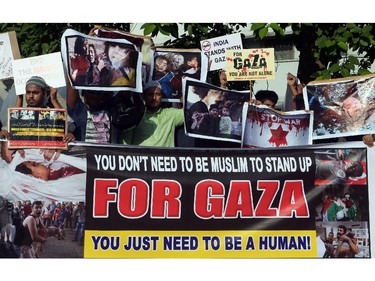 Indian protestors hold posters and banners during an anti-Israel protest in Kolkata on July 26, 2014. Thousands of protesters from London to India rallied to voice their support for Palestinians as world pressure built-up for a ceasefire in Gaza. The 19-day conflict between Israeli forces and the Islamist militant movement that controls the Gaza Strip, has killed more than 845 people, most of them Palestinian civilians.