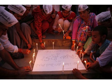 Indian activists of the Aam Aadmi Party, or Common Man Party, light candles during an event to mark the 15th anniversary of India's victory in the Kargil War, in Allahabad, India, Saturday, July 26, 2014. The 1999 conflict with Pakistan raged for three months across the disputed Kashmir region and nearly brought the nuclear neighbors to a war. The poster reads �On the 15th anniversary of the Kargil War, a grateful nation bows down to you.�