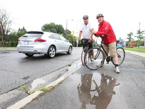 Beacon Hill-Cyrville Coun. Tim Tierney, right, shown with Innes Ward Coun. Rainer Bloess, says the absence of a bike lane or any other cycling infrastructure along a one-kilometre stretch of busy Ogilvie Road is the missing link for cyclists travelling between eastern and western parts of the city.