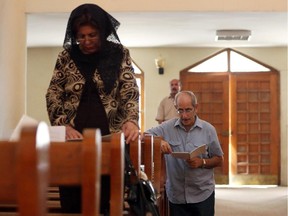 Iraqi Christians pray during Sunday Mass at the Church of Virgin Mary in Baghdad, Sunday, July 27, 2014.