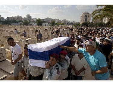 Israeli soldiers carry the coffin of Warrant Officer Rami Cahlon during his funeral at the military cemetery in Hadera, northern Israel, Sunday, July 27, 2014. Cahlon was injured during fighting in Gaza and died from his wounds four days later.