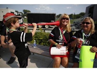 Jackson MacNeill makes some noise for mom Barb and Maureen Lyons, who all came from Arnprior to see the Redblacks' home opener at TD Place on Friday, July 18, 2014.