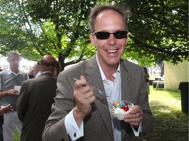 Jason Cameron, one of the 3,000 guests of the U.S. Embassy's annual Independence Day party on Friday, July 4, 2014, fuels up at the sundae bar.