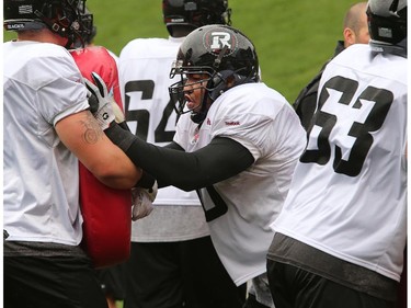 Jeraill McCuller (#50, centre) gets put through some paces with other offensive linemen during drills as the Ottawa Redblacks practice through a downpour Tuesday morning at TD Place Stadium at Lansdowne Park.