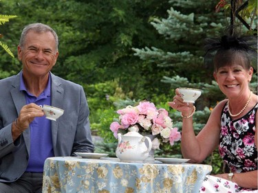 Jerry Gaudreau and Jackie Gaudreau get their photo taken in the garden-setting photo booth at the High Tea for Ryan's Well Foundation, held Sunday, July 20, 2014, in Plaisance, Quebec.