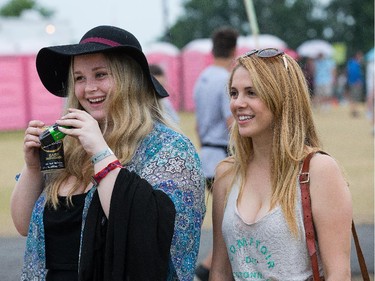 Jody Heaves, 19, left, and Feli Langlois, 19, take in the sites at Bluesfest Tuesday evening.