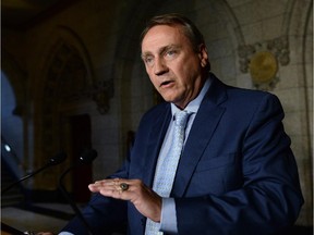 Minister John Duncan in his capacity as Chair of the Board of Internal Economy answers questions after delivering a statement on Parliament Hill in Ottawa on Tuesday, June 3, 2014. THE CANADIAN PRESS/Sean Kilpatrick