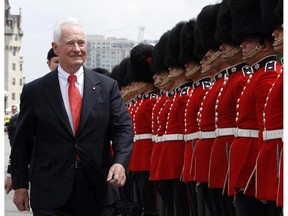 Governor General David Johnston inspects the Guard of Honour during Canada Day celebrations on Parliament Hill in Ottawa, Tuesday July 1, 2014.