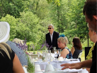 Journalist Shawn McCarthy, board chair of Ryan's Well Foundation, addresses the crowd at a high tea charity event held Sunday, July 20, 2014, at a private home in Plaisance, Que. in support of Ryan's Well Foundation.