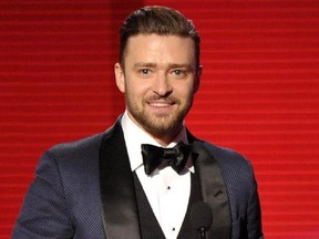 FILE - In this Nov. 24, 2013 file photo, Justin Timberlake accepts the award for favorite album - soul/R&B for "The 20/20 Experience" at the American Music Awards in Los Angeles. In the Coen brothers� �Inside Llewyn Davis� Timberlake plays a supporting role as a cheery, sweater-wearing 1960s folk musician. But he also collaborated with producer T Bone Burnett on the movie�s memorable period songs and helped shape the film�s most unforgettable and comic tune, �Please Mr. Kennedy.�