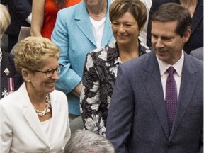 Ontario's Premier Kathleen Wynne (left) greets former Premier Dalton McGuinty (centre) as she arrives with Lt.-Gov. David Onley for the Throne Speech at Queens Park in Toronto on Thursday July 3, 2014.