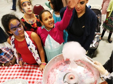 Kids enjoy watching the cotton candy being made at the Eid celebrations held at the EY Centre in Ottawa, July 28, 2014.