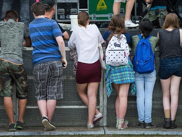 Kids wait for the first act, Jenny Lewis, at the River Stage at Bluesfest Tuesday evening.