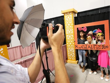 Left to right in frame: Doha Alhafez, Naima Aden, Mawadda Rezgui, Tasneem Hafez, Aminah Alwarfilee, Zainah Salah have their picture taken by Othman Tmoulik during Eid celebrations held at the EY Centre in Ottawa, July 28, 2014.