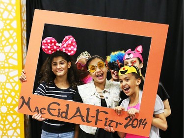 Left to right in frame: Doha Alhafez, Naima Aden, Mawadda Rezgui, Tasneem Hafez, Aminah Alwarfilee, Zainah Salah have their picture taken by Othman Tmoulik during Eid celebrations held at the EY Centre in Ottawa, July 28, 2014.