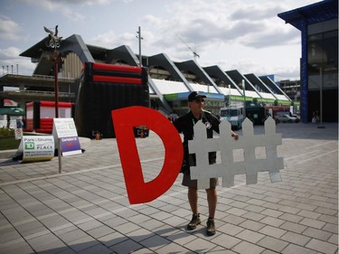 Lance Vickers, a season tickets holder, holds his defense signs before the Redblacks' home opener at TD Place on Friday, July 18, 2014.