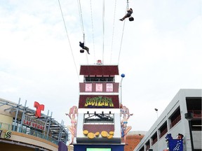 Visitors ride the SlotZilla zip line attraction at the Fremont Street Experience in Las Vegas.