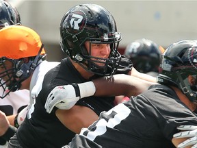 Former Argo, now Redblacks linebacker Jason Pottinger (centre) gets in the mix at practice.