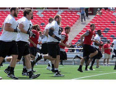 Linebackers do running drills during practice as the Ottawa Redblacks practice at TD Place Stadium at Lansdowne Park on Monday, July 14, 2014.