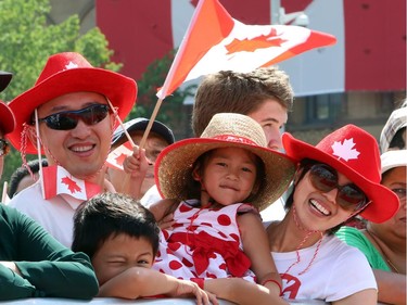 Ron Liu along with his six-year-old son Robbie and four-year-old daughter Elaine and his wife May (left to right) take part in Canada Day celebrations on Parliament Hill in Ottawa.