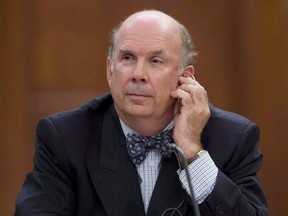 Justice Marc Nadon, seen on Parliament Hill in Ottawa on October 2, 2013, won't be required to repay his salary as a Supreme Court justice, says Justice Minister Peter MacKay.