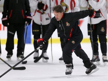 Skating coach Marc Power demonstrates skating technique for the Ottawa Senators' NHL prospects during their annual development camp at the Bell Sensplex on Friday, July 4, 2014.