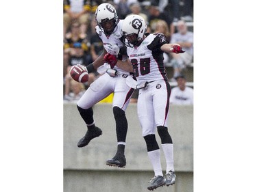 Ottawa RedBlacks receiver Marcus Henry, left, celebrates his touchdown with teammate Matt Carter as they take on the Hamilton Tiger-Cats in CFL action in Hamilton, Ont., Saturday, July 26, 2014.