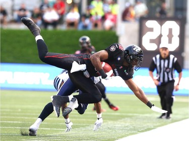 Marcus Henry of the Ottawa Redblacks is tackled by the Toronto Argonauts at TD Place in Ottawa during the franchise home opener of the Redblacks on Friday, July 18, 2014.