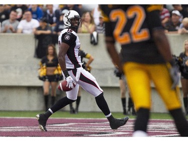 Ottawa RedBlacks receiver Marcus Henry smiles as he crosses into the end zone for a touchdown against the Hamilton Tiger-Cats in CFL action in Hamilton, Ont., Saturday, July 26, 2014.