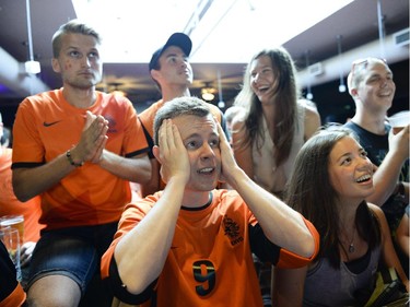 Marek Wisniewki, centre, cheering for Netherlands reacts during the FIFA World Cup 2014 match between Netherlands and Argentina at Hooley's on Wednesday, July 9, 2014.