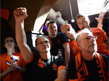 Marek Wisniewki, centre, cheers for Netherlands during the FIFA World Cup 2014 match between Netherlands and Argentina at Hooley's on Wednesday, July 9, 2014.