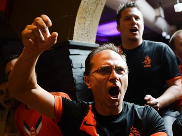 Marek Wisniewki, left, cheers for Netherlands during the FIFA World Cup 2014 match between Netherlands and Argentina at Hooley's on Wednesday, July 9, 2014.