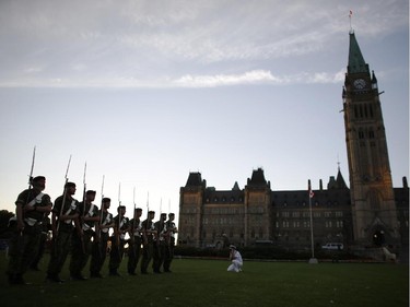 Massed military bands, along with The Band of the Ceremonial Guard, rehearse on Wednesday evening, July 23, 2014 for the 18th annual Fortissimo – a free military and musical performance – on Parliament Hill, which will take place from Thursday to Saturday, starting at 7:30 p.m. each night.