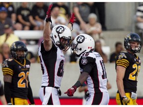 Ottawa Redblacks slot back Matt Carter celebrates his touchdown with teammate Kierrie Johnson, right.