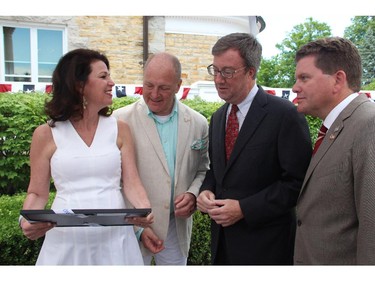 Mayor Jim Watson and Deputy Mayor Steve Desroches arrive bearing a gift for U.S. Ambassador Bruce Heyman and his wife, Vicki, at the embassy's annual Independence Day party, held Friday, July 4, 2014, in Rockcliffe.