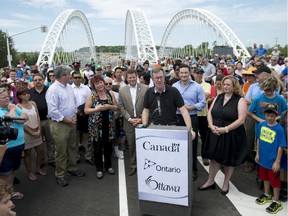 Mayor Jim Watson speaks during the grand opening of the Strandherd-Armstrong Bridge in Ottawa on Saturday, July 12, 2014. The bridge connects the communities of Barrhaven and Riverside South over the Rideau River.