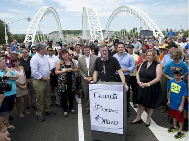 Mayor Jim Watson speaks during the grand opening of the Strandherd-Armstrong Bridge in Ottawa on Saturday, July 12, 2014. The bridge connects the communities of Barrhaven and Riverside South over the Rideau River.