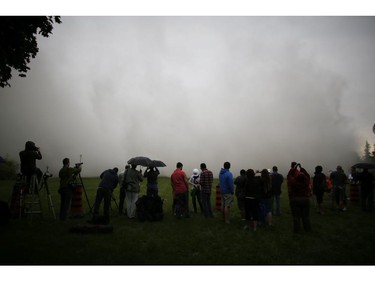 Members of the media and others in the VIP viewing box for the demolition of the Sir John Carling Building saw a wall of dust approach quickly after the building went down on Sunday morning, July 13, 2014.