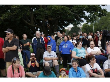 Members of the public gathered at a vantage point near Carling Road early Sunday morning to watch as the Sir John Carling Building in Ottawa was demolished, July 13, 2014.