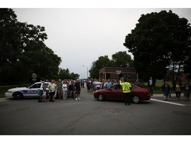 Members of the public gathered early Sunday morning to watch as the Sir John Carling Building in Ottawa was demolished, July 13, 2014.