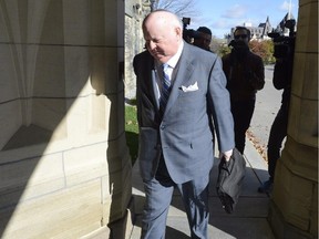 Sen. Mike Duffy arrives to the Senate on Parliament Hill in Ottawa, in an October 28, 2013 photo. e RCMP have laid 31 charges of fraud, breach of trust and bribery against suspended Sen. Mike Duffy.