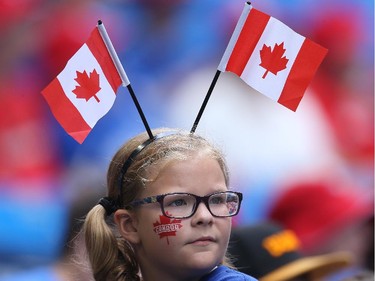 A young fan of the Toronto Blue Jays celebrates Canada Day before the start of MLB game action against the Milwaukee Brewers on July 1, 2014 at Rogers Centre in Toronto, Ontario, Canada.