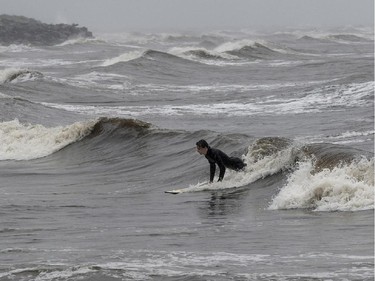 Miramichi surfer Shaune Nizan takes advantage of tropical Arthur's high waves in Escuminac, N.B. on Saturday, July 5, 2014.