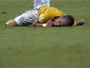 Brazil's Neymar grimaces after being fouled during the World Cup quarterfinal soccer match between Brazil and Colombia at the Arena Castelao in Fortaleza, Brazil, Friday, July 4, 2014. Brazil's team doctor says Neymar will miss the rest of the World Cup after breaking a vertebrae during the team's quarterfinal win over Colombia.