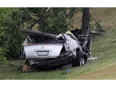 Nissan Atima in ditch after colliding with Toyota Corolla (not pictured) at the intersection of March Rd. and Carling Ave. in Kanata (Ottawa), Sunday, July 27, 2014. Two are dead and two others are in hospital with life-threatening injuries.