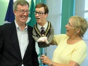 Noreen Young presents Ottawa mayor Jim Watson with his very own "mini me" at an unveiling Wednesday, July 23, 2014, at City Hall. Ms. Young is Founder and Artistic Director of the 10th Annual Puppets Up International Puppet Festival, held this year on Aug 9th and 10th in Almonte and featuring world-class puppet performances and shows from Canada, U.S., Italy and Switzerland. Mayor Watson and his puppet will be the Parade Marshall at the parade on  Saturday, from 1.45 - 2.15 p.m. (Julie Oliver / Ottawa Citizen)