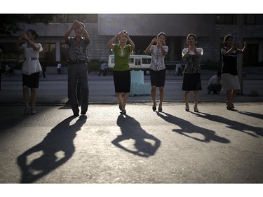 North Koreans gather for a dance in downtown Pyongyang, Sunday, July 27, 2014 in North Korea. North Korea celebrated its 61st anniversary of the armistice that ended the Korean War Sunday, and took the opportunity to spend their Sunday off, a national holiday, with family and friends.