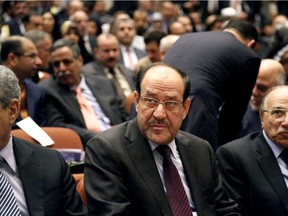 Iraqi Prime Minister Nouri al-Maliki, center, attends the first session of parliament in the heavily fortified Green Zone in Baghdad, Iraq, Tuesday, July 1, 2014.