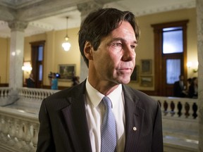 Dr. Eric Hoskins makes his way to a cabinet briefing after being sworn in as Health Minister at Queens Park in Toronto on Tuesday June 24, 2014. THE CANADIAN PRESS/Chris Young