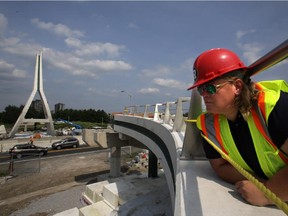 Ottawa Councillor Maria McRae looks over still unfinished Airport Parkway pedestrian and cyclist bridge in Ottawa this week.